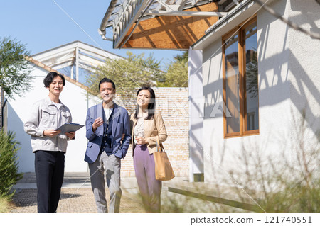 A businessman and a middle-aged couple working at a construction site A businessman and a middle-aged couple working at a construction site 121740551