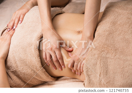 Young Asian woman getting a belly oil massage. 121740735