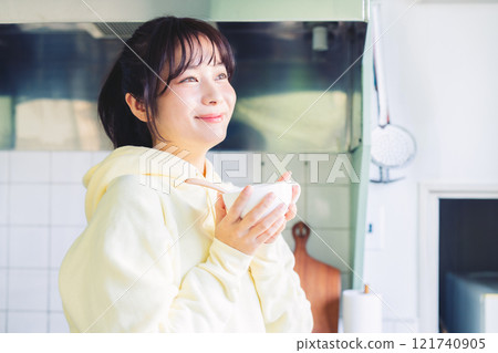 A woman drinking soup 121740905