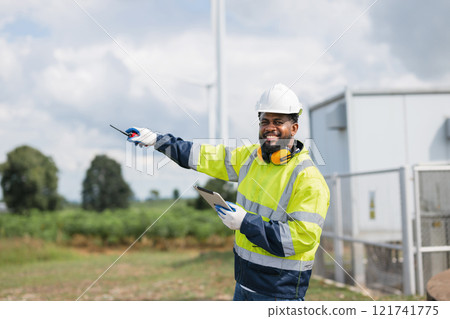 man in a yellow and blue safety vest is pointing to something 121741775