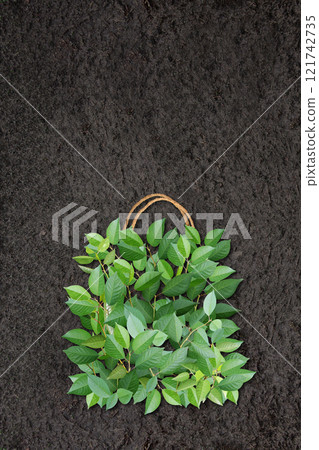 Vertical Eco background with soil and shopping bag made from green leaves. Responsible consumption. Eco-friendly agricultural business. Ecology and zero waste concept. Copy space for text 121742735