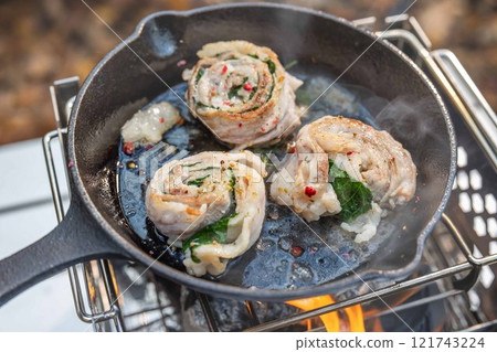 Outdoor cooking: Camping cooking with a small iron pan 121743224