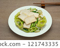 close up view of stir fried hard tofu with banana pepper in a ceramic dish on wooden table. asian homemade style healthy food concept. 121743335