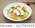 homemade style of stir fried hard tofu and egg noodles in a ceramic dish on wooden table, close up. asian food concept. 121743339