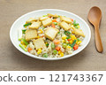 close up view of fried rice with hard tofu and vegetable in a ceramic dish on wooden table. vegan homemade style food concept. 121743367
