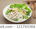 close up view of homemade style rice noodle with chicken meat and vegetable in a ceramic bowl on wooden table. asian food concept. 121743368