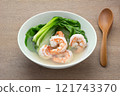 homemade style of bok choy clear soup with shrimp in a ceramic bowl on wooden table, close up. asian food comcept. 121743370