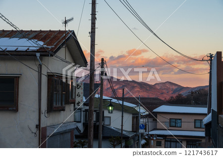 A view of the mountains dyed in the setting sun: Evening scenery in Kusatsu town 121743617