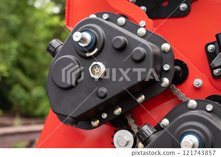 Close-up of red agricultural machinery with measuring scale. 121743857