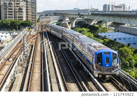 View of a Taoyuan International Airport line train running on the elevated track of the Taoyuan Mass Rapid Transit System. View of a Taoyuan International Airport line train running on the elevated track of the Taoyuan Mass Rapid Transit System. 121743922