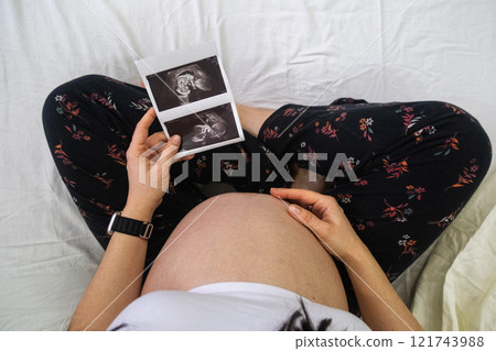 Pregnant Woman Holding Ultrasound Images Pregnant Woman Holding Ultrasound Images 121743988
