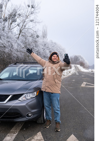 Man Taking Selfie with SUV on Snowy Roadside Man Taking Selfie with SUV on Snowy Roadside 121744004
