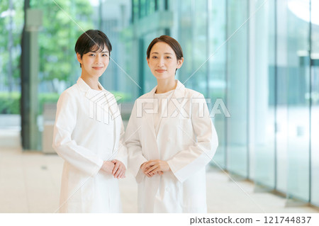 Portrait of two women in white coats 121744837