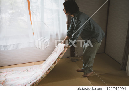 A woman laying a futon 121746094