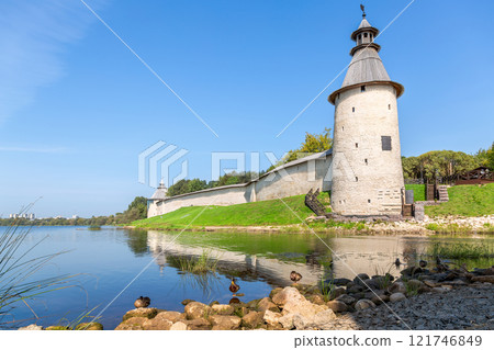 Ancient walls and towers of the medieval Pskov kremlin on the Velikaya river in summer Ancient walls and towers of the medieval Pskov kremlin on the Velikaya river in summer 121746849