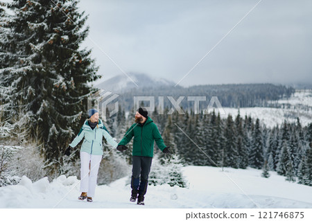 Couple in the middle of snowy nature. Hiking in winter mountains. Couple in the middle of snowy nature. Hiking in winter mountains. 121746875