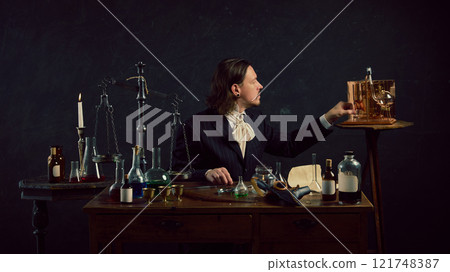 Mysterious figure, doctor sits amidst vintage lab equipment, appearing to carefully measure ingredients, possibly elixir or alcohol. 121748387
