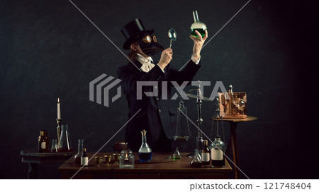 Plague doctor exam green liquid in flask, blending science fiction with historical themes in vintage laboratory against dark mystery background. Plague doctor exam green liquid in flask, blending science fiction with historical themes in vintage laboratory against dark mystery background. 121748404