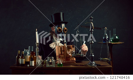 Mysterious person in plague doctor mask surrounded by equipment in vintage laboratory against dark mystery background. Mysterious person in plague doctor mask surrounded by equipment in vintage laboratory against dark mystery background. 121748416