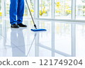 A professional janitor mopping clean floors in a bright facility during daytime, maintaining a hygienic environment 121749204