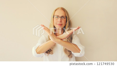 Upset woman shows stop, no or enough sign with palm of hand, refusal gesture, domestic violence 121749530