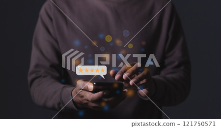 Young Man hand holding Smart Phone with five star to review and give 5 stars with very good Young Man hand holding Smart Phone with five star to review and give 5 stars with very good 121750571