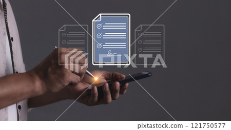 Young man hand holding smartphone mobile using a pen touching to sign a Contract signing 121750577