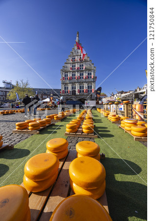the town hall in the Netherlands and cheeses standing in front of it 121750844