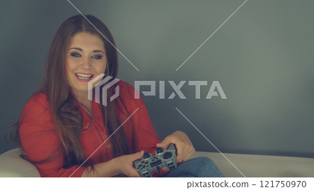Young woman playing video games 121750970