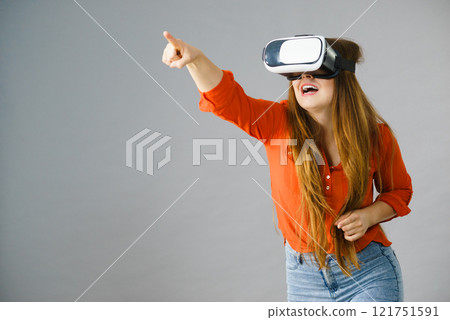 Girl wearing virtual reality goggles. Girl wearing virtual reality goggles. 121751591