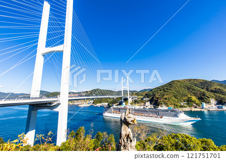 Cruise ship departing from Nagasaki Port (Adora Mediterranea) passing Megami Ohashi Bridge Kanzaki Shrine (Kankari Inari) [Nagasaki City] 121751701