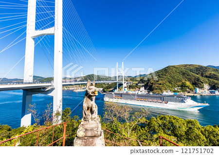 Cruise ship departing from Nagasaki Port (Adora Mediterranea) passing Megami Ohashi Bridge Kanzaki Shrine (Kankari Inari) [Nagasaki City] 121751702