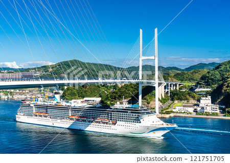 Cruise ship departing from Nagasaki Port (Adora Mediterranea) passing Megami Ohashi Bridge Kanzaki Shrine (Kankari Inari) [Nagasaki City] 121751705