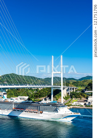 Cruise ship departing from Nagasaki Port (Adora Mediterranea) passing Megami Ohashi Bridge Kanzaki Shrine (Kankari Inari) [Nagasaki City] 121751706