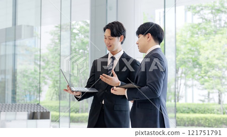 Businessmen having a meeting in the lobby 121751791