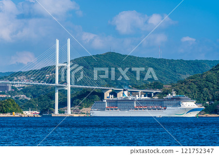 Passenger ship arriving at Nagasaki Port (Adora Mediterranea) passing Megami Ohashi Bridge from the Island of the Gods [Nagasaki City] 121752347