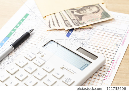 Tax return documents and a calculator on a desk Tax return documents and a calculator on a desk 121752606