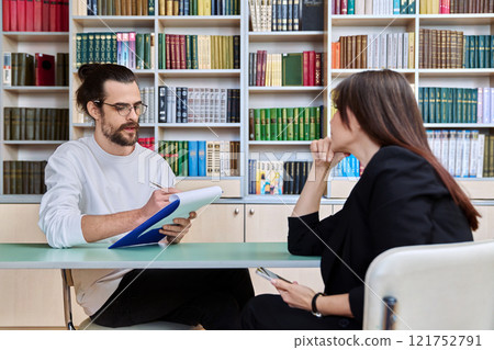 Young male mental health specialist working with mature female patient Young male mental health specialist working with mature female patient 121752791