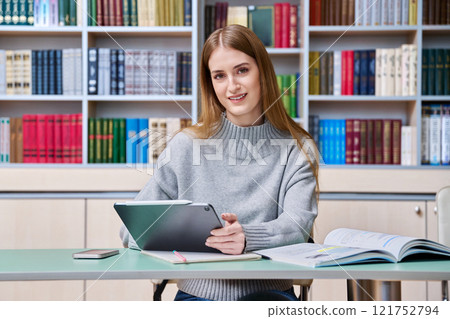 Teenage girl student studying in high school library Teenage girl student studying in high school library 121752794