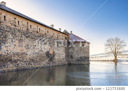 Svihov castle surrounded by a moat in winter, medieval landmark in Region Pilsen in Czech Republic, Europe. 121753880