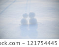 Snowmen huddling together. 121754445