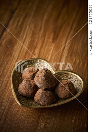 Chocolate truffles served in a heart-shaped container Chocolate truffles served in a heart-shaped container 121755032