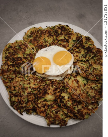 Delicious zucchini carrot pancakes with fried eggs for valentine's day Delicious zucchini carrot pancakes with fried eggs for valentine's day 121755851