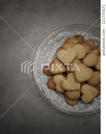 Heart shaped cookies filling a glass plate, creating a sweet valentine's day scene 121755871
