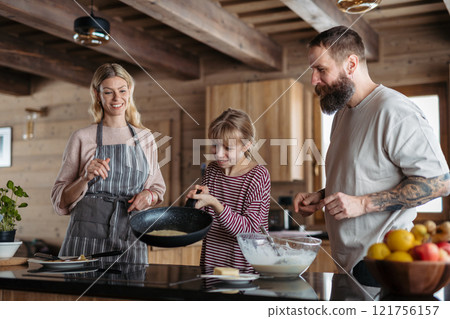 Family making pancakes, preparing sweet breakfast in the morning. 121756157