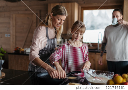 Family making pancakes, preparing sweet breakfast in the morning. 121756161