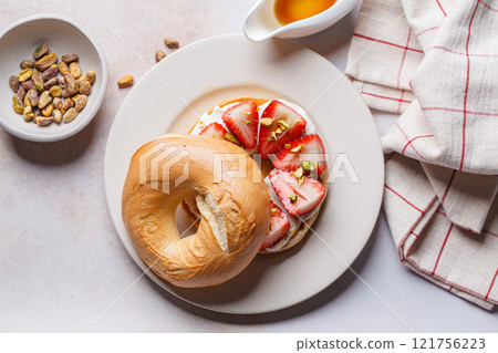 Breakfast bagels with cream cheese and strawberries. Breakfast bagels with cream cheese and strawberries. 121756223