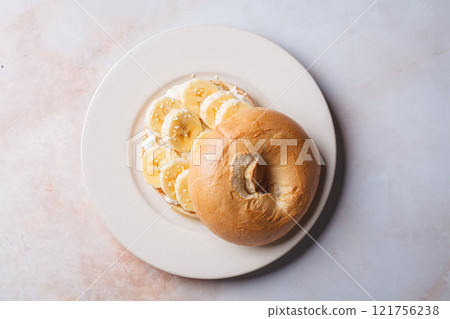 Breakfast bagels with cream cheese, banana and sesame. Breakfast bagels with cream cheese, banana and sesame. 121756238