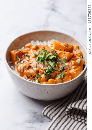 Vegan curry chickpea stew with vegetables in white bowl. Vegan curry chickpea stew with vegetables in white bowl. 121756251