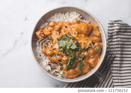 Vegan curry chickpea stew with vegetables in white bowl. Vegan curry chickpea stew with vegetables in white bowl. 121756252